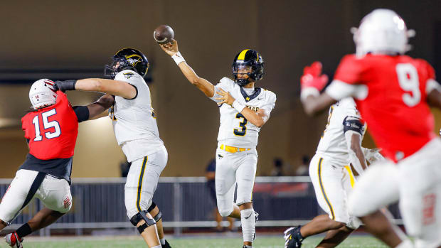 American Heritage quarterback Dia Bell throwing against Milton defense 