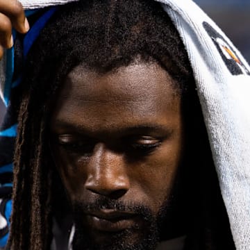 CHARLOTTE, NORTH CAROLINA - AUGUST 17: Jadeveon Clowney #7 of the Carolina Panthers stands on the sideline with a Gatorade towel on his head during a preseason game against the New York Jets at Bank of America Stadium on August 17, 2024 in Charlotte, North Carolina.