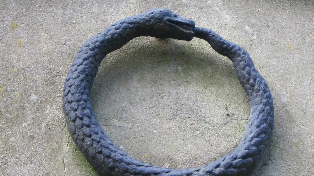 An ouroboros on a grave marker in West Highgate Cemetery, London.