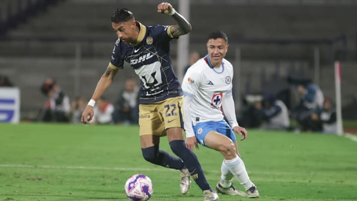 Robert Ergas #22 of Pumas UNAM drives the ball forward...