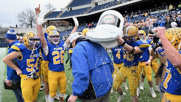 Marion Local players pour water over head. coach Tim Goodwin after winning the 2023 Division VII state championship game.