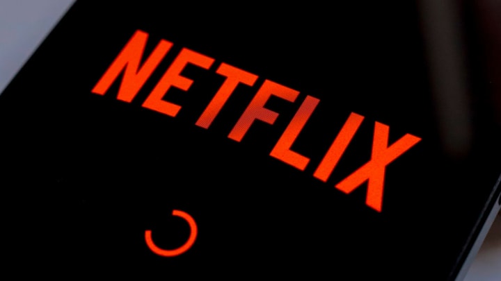 In this photo illustration, the Netflix streaming app logo...