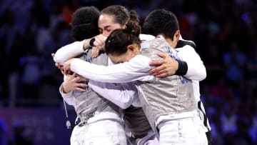 Jacqueline Dubrovich, Maia Weintraub, Lauren Scruggs and Lee Kiefer of Team USA celebrate winning against Team Italy during the women's team foilgold medal match.