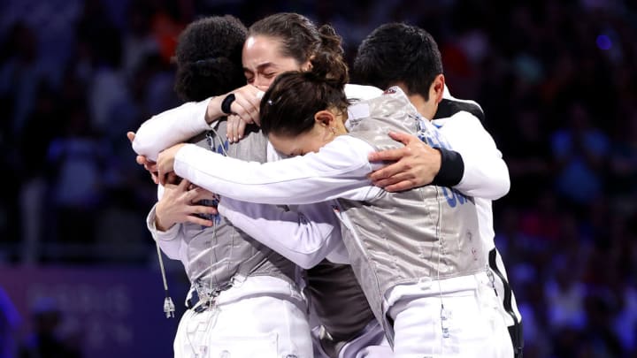 Jacqueline Dubrovich, Maia Weintraub, Lauren Scruggs and Lee Kiefer of Team USA celebrate winning against Team Italy during the women's team foilgold medal match.