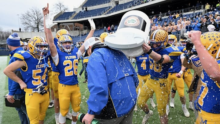 Marion Local players dump water on head coach Tim Goodwin after winning the 2023 OHSAA Division VII state championship game.