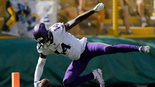 Minnesota Vikings wide receiver Stefon Diggs (14) dives into the end zone for a touchdown reception against the Green Bay Pac