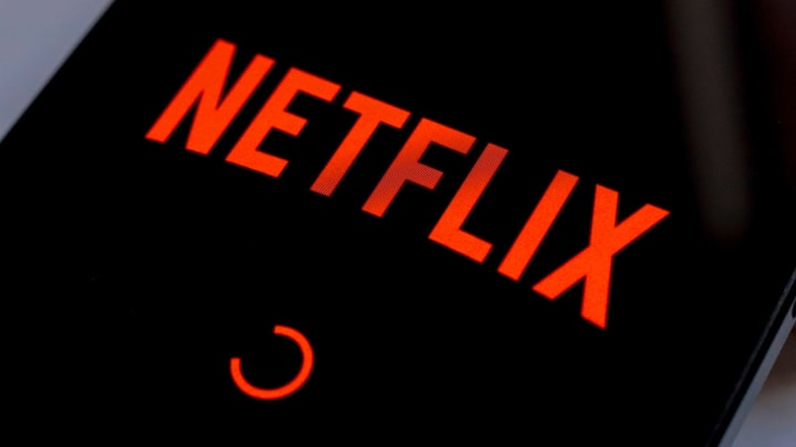 In this photo illustration, the Netflix streaming app logo...