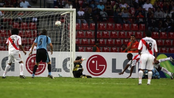 Peru's player Miguel Villalta(2 R) dives...