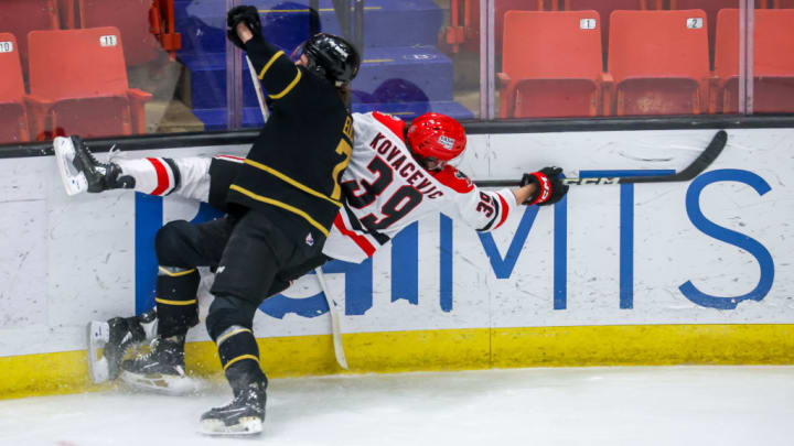 Blue Jackets draft pick Charlie Elick (7, black) checks an opposing player.