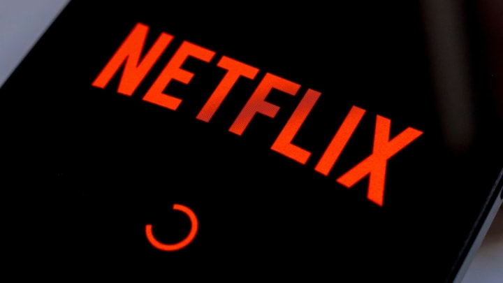 In this photo illustration, the Netflix streaming app logo...