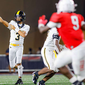 American Heritage quarterback Dia Bell throws against Milton (Georgia) in an August 2024 matchup. Milton won that game 37-28.
