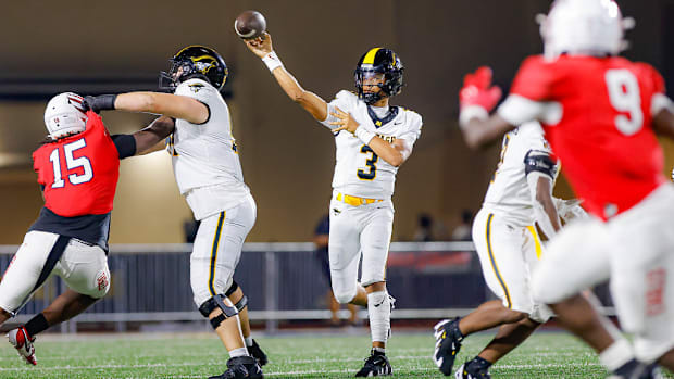 American Heritage quarterback Dia Bell throwing against Milton defense 