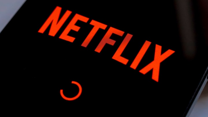 In this photo illustration, the Netflix streaming app logo...