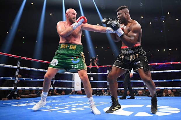 Tyson Fury and Francis Ngannou exchange punches during their heavyweight bout in Riyadh, Saudi Arabia.