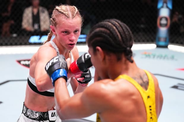 Carli Judice punches Gabriella Fernandes in a flyweight fight during a UFC Fight Night event.