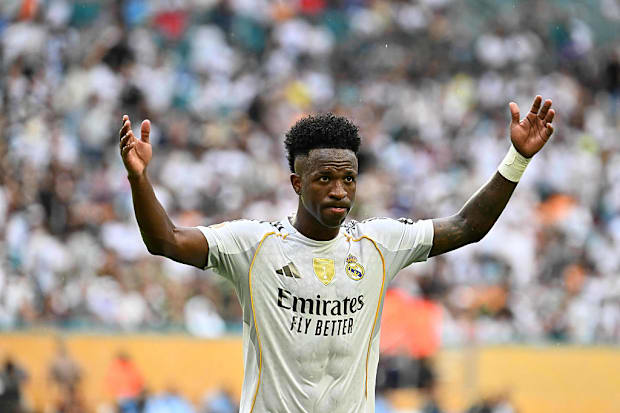 Vinícius Júnior celebrating with raised arms.
