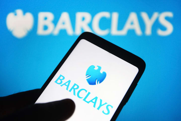 In this photo illustration a Barclays plc logo is seen on a...