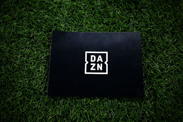 A sign bearing the DAZN logo is visible on the field...