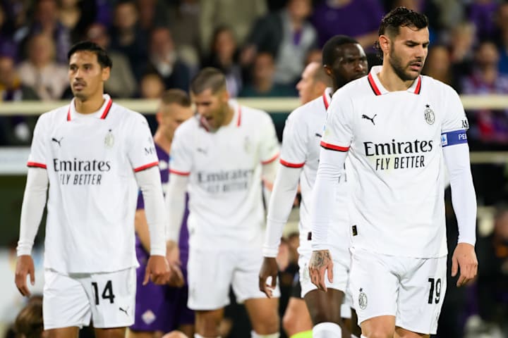 Theo Hernandez of AC Milan (r) and team mates look dejected...