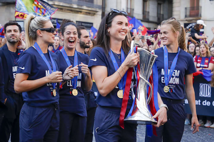 FC Barcelona women's football team celebrates their third Champions League trophy