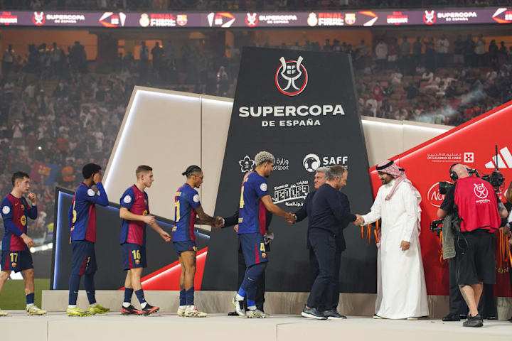 Barcelona players receive medals after winning the Spanish...