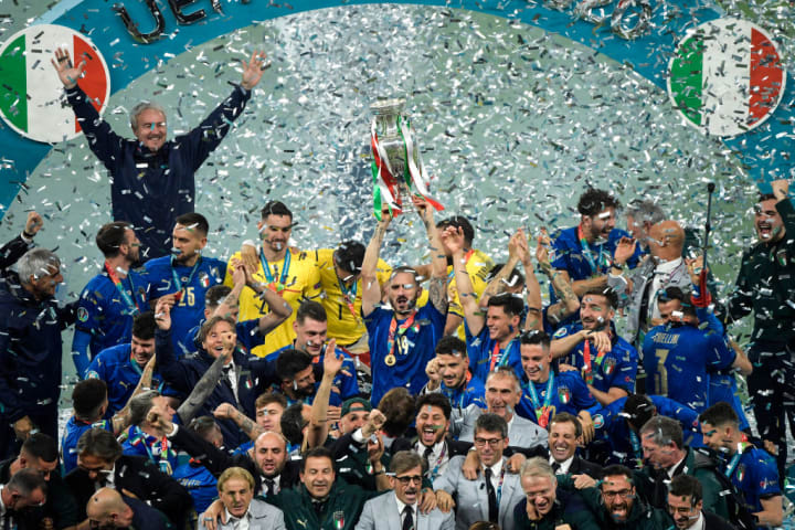 Leonardo Bonucci of Italy holds the trophy while the italian...