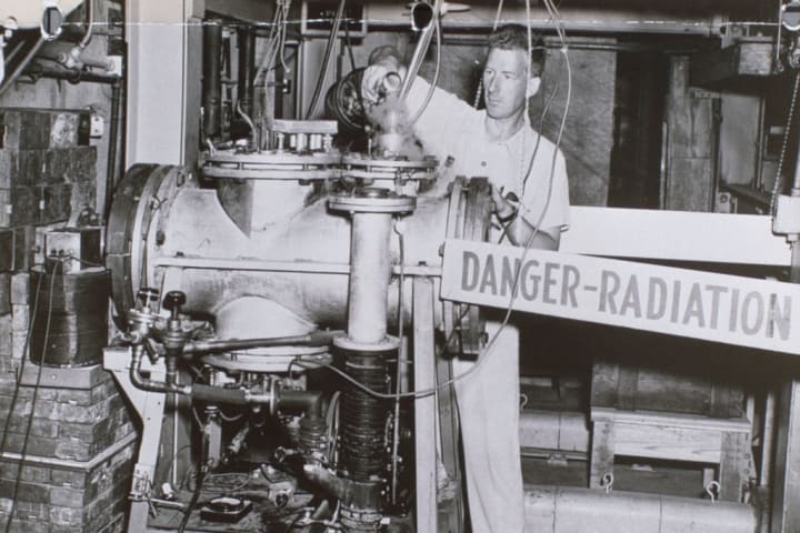 Technician at Oak Ridge laboratory handling radioactive material