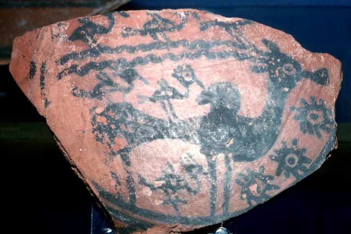A sherd of pottery painted with a humped bull and birds from the Indus Valley, circa 2600 BCE.