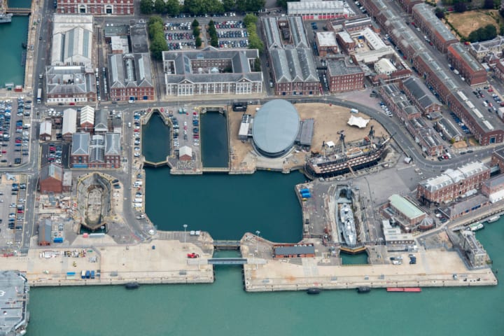 The ‘Mary Rose’ museum (the oval in the center of the photo) was built around the ship in Portsmouth dockyard. 