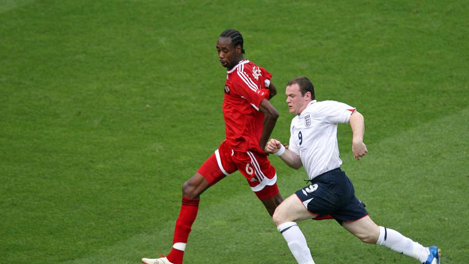 Dennis Lawrence is challenged by Wayne Rooney during the World Cup match between England vs. Trinidad and Tobago.