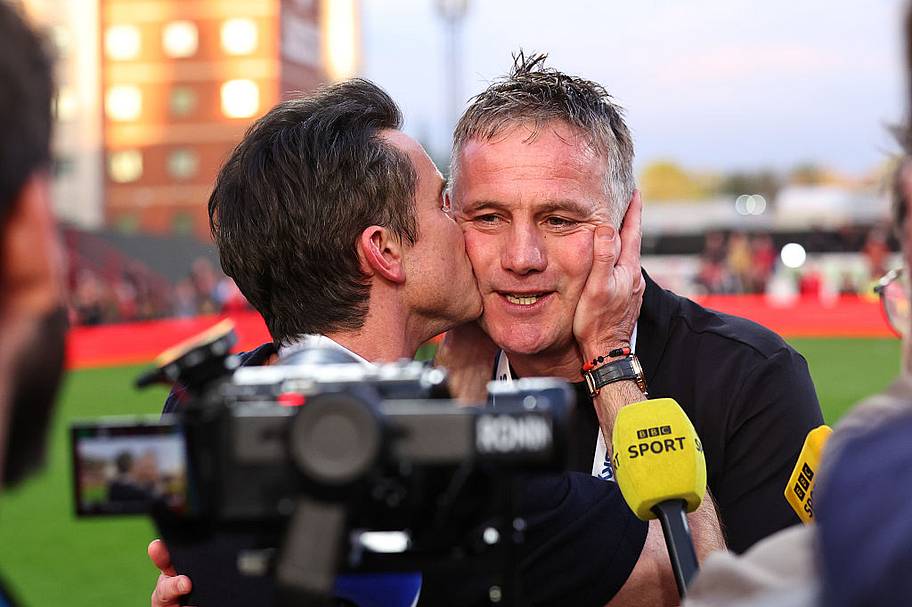 Rob McElhenney co owner of Wrexham kisses Phil Parkinson manager of Wrexham during a BBC Sport interview.
