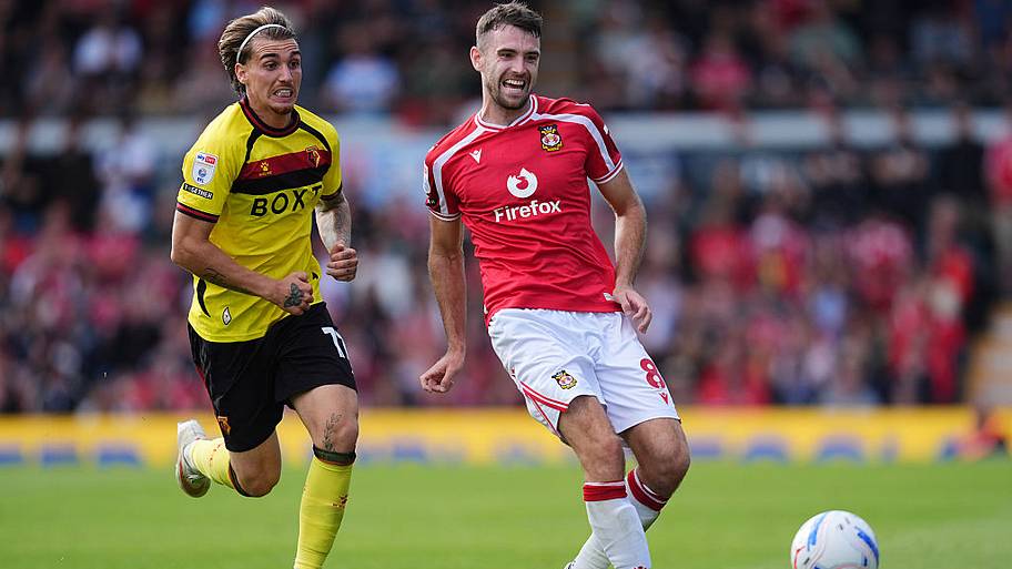 Watford's Iker Bravo (left) and Wrexham's Ben Whiteman in action during the Sky Bet Championship match