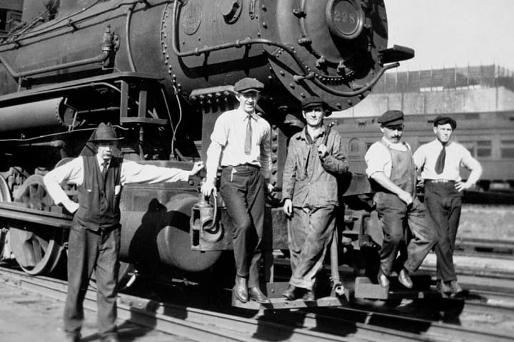 Railroad workers beside a Rock Island Line train circa 1920