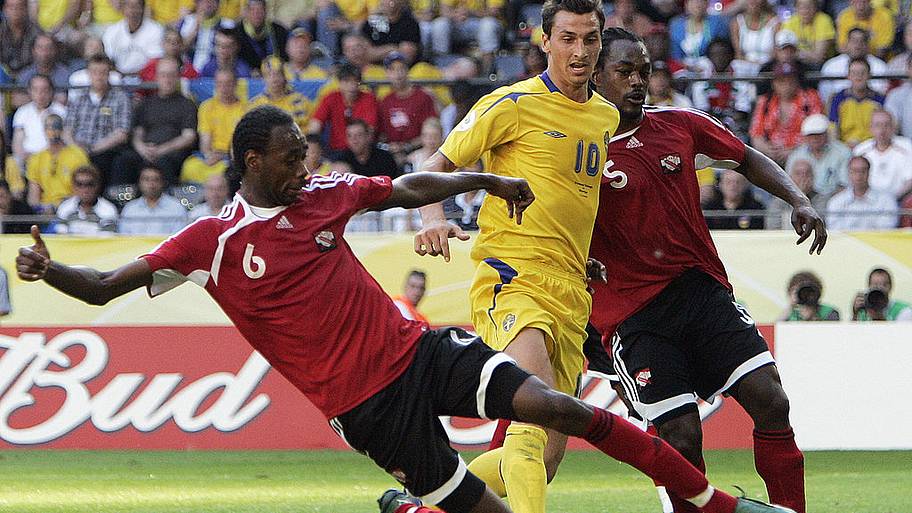 Dennis Lawrence battles Zlatan Ibrahimovic for the ball.