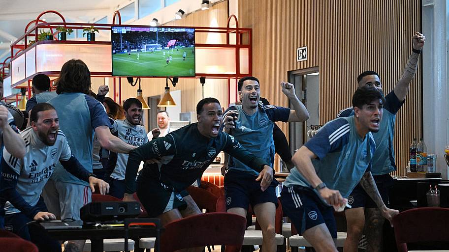Arsenal players watch Bournemouth vs. Man Cit