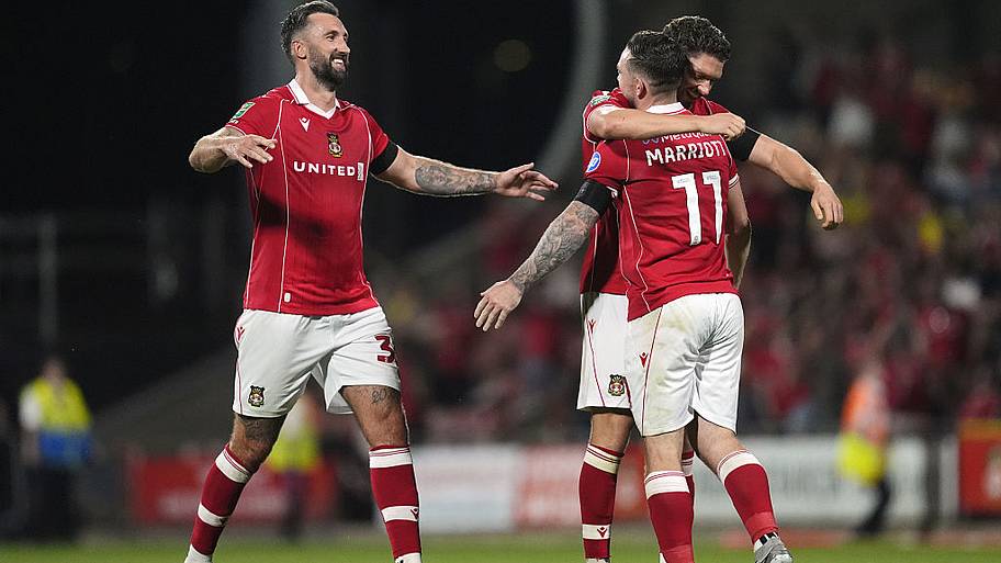 Ollie Palmer and teammates George Evans and Jack Marriott celebrate after Wrexham win the Carabao Cup first round.