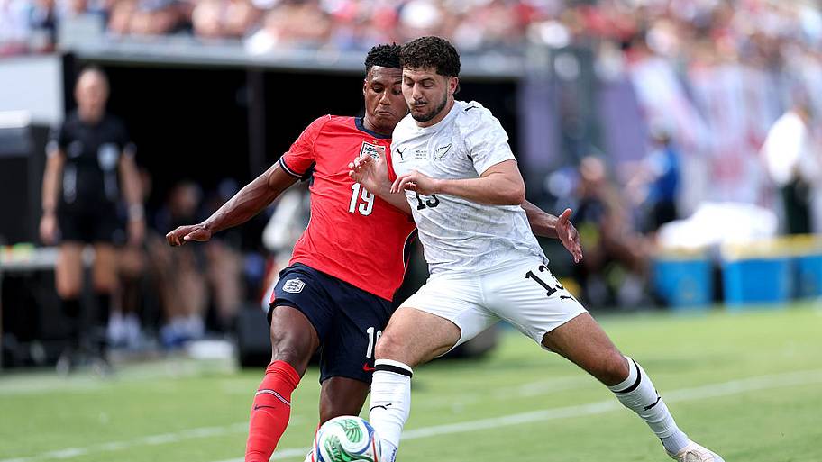 Ollie Watkins of England is challenged by Liberato Cacace of New Zealand.