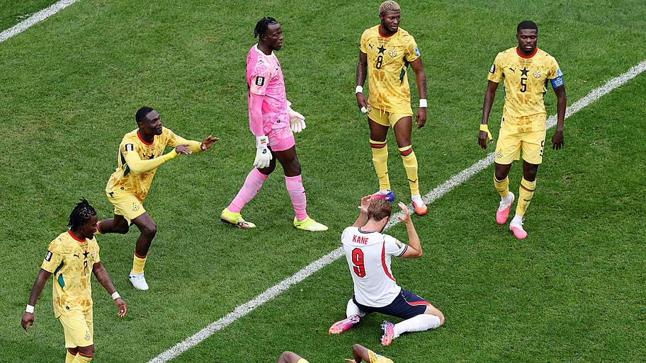 Ghana players surround Harry Kane