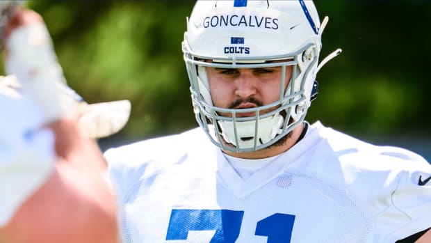 Colts offensive tackle Matt Goncalves (all-white uniform with blue trim) waits for the next drill during training camp. 