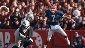 In true Flutie form, Doug Flutie leaps high to get a pass over Raiders LB Lance Johnstone.