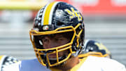 Murphy's Yousef Mugharbil (73) listens to head coach Jeff Craddock during pregame warmups in Carter-Finley Stadium for the 2021 NCHSAA 1AA Football Championship on Saturday, May 8th, 2021. The Murphy Bulldogs defeated the Northside Panthers 14-7.