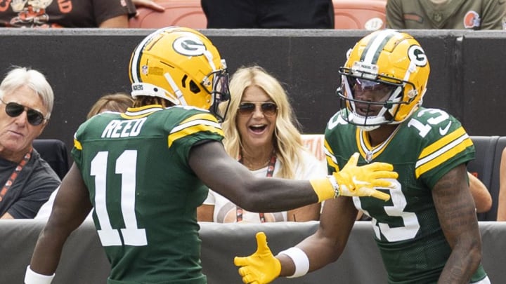 Green Bay Packers receiver Jayden Reed (11) congratulates receiver Dontayvion Wicks (13) on his touchdown reception against the Cleveland Browns.