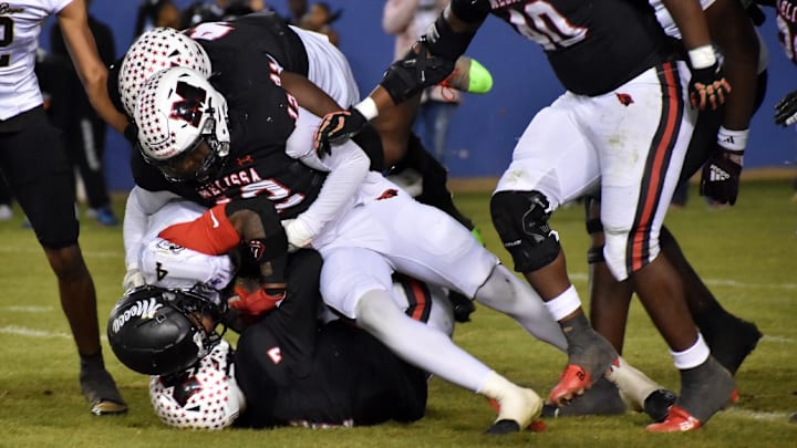 South Oak Cliff's Levon Morton is tackled by a trio of Melissa defenders in a game on Dec. 12. South Oak Cliff's Levon Morton is tackled by a trio of Melissa defenders in a game on Dec. 12.