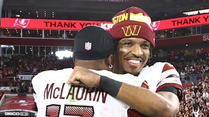 Washington Commanders quarterback Jayden Daniels hugs receiver Terry McLaurin after winning a playoff game.