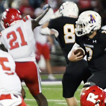 Alexandria Senior High’s quarterback gets past Ruston defenders in a district game held Friday in Alexandria. ASH won 40-36 and is 8-0 on the season.