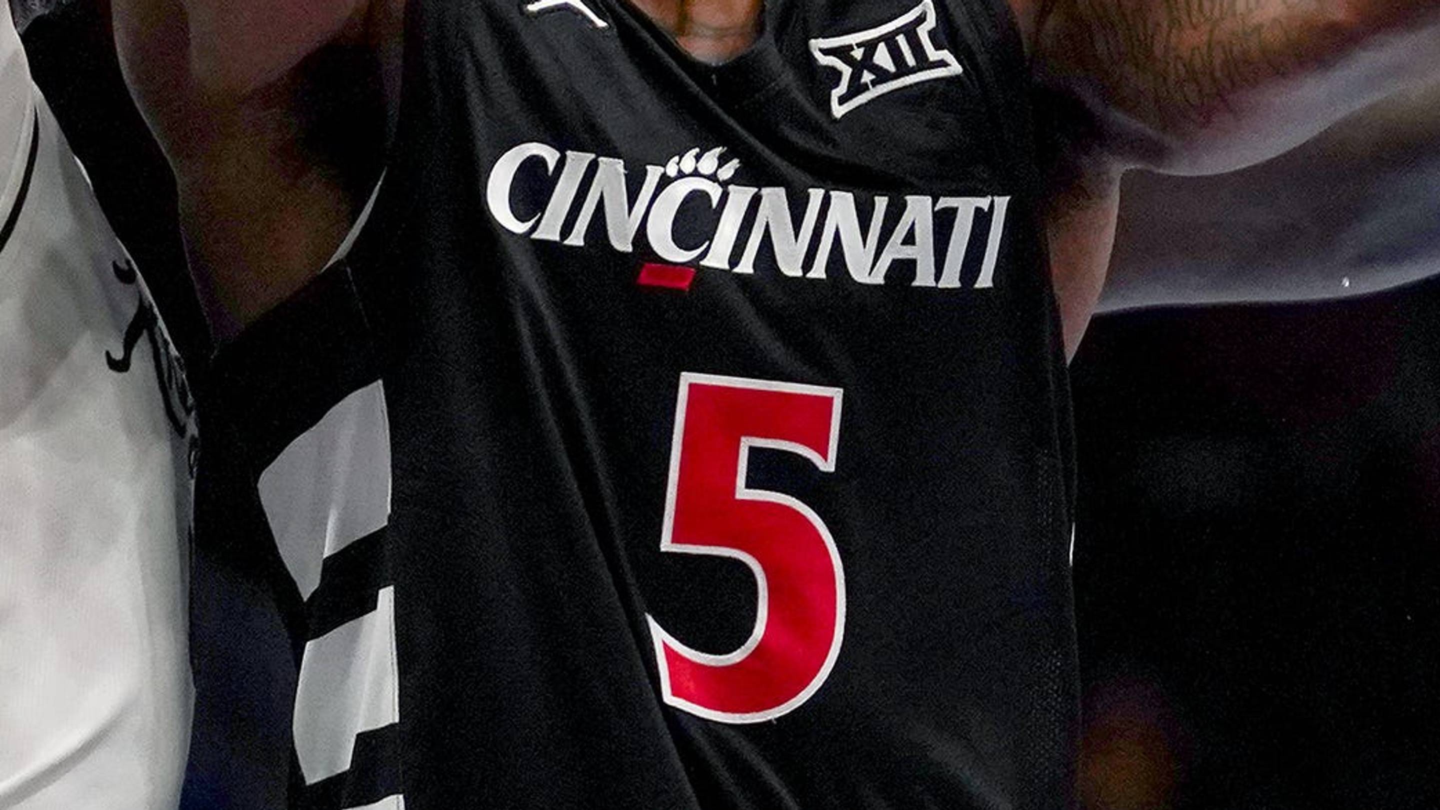Cincinnati Bearcats guard Sencire Harris (5) is double teamed by UCF Knights players in the first half of the second round of the Phillips 66 Big 12 Men’s Basketball Tournament between the Cincinnati Bearcats and UCF Knights, Wednesday, March 11, 2026, at T-Mobile Center in Kansas City, MO. | USA TO