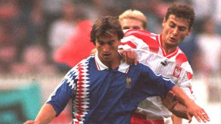 French striker David Ginola (front) is challenged