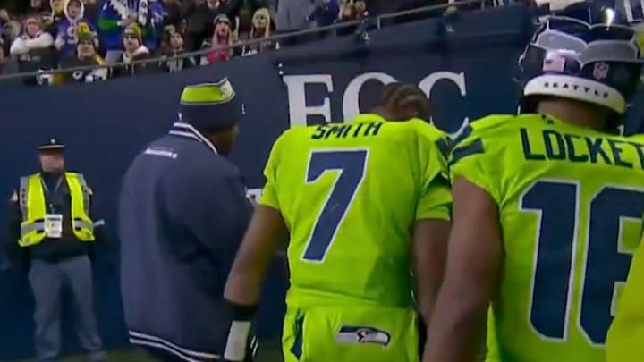 Geno Smith heads into the locker room accompanied by Tyler Lockett Geno Smith heads into the locker room accompanied by Tyler Lockett