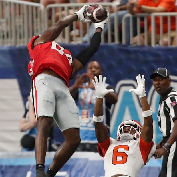 Malaki Starks (24) picks off a pass Malaki Starks (24) picks off a pass