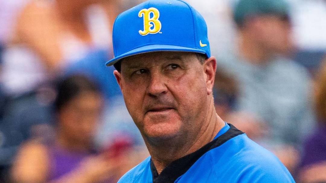 Jun 16, 2025; Omaha, Neb, USA; UCLA Bruins head coach John Savage walks off the field before the game against the LSU Tigers at Charles Schwab Field. Mandatory Credit: Dylan Widger-Imagn Images